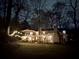 Stunning home exterior with string lights across the yard at night at 192 Maple Wood Dr, Lawrenceville, GA 30046