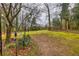 Extensive backyard featuring mature trees, a grassy area, and space for outdoor activities and relaxation at 192 Maple Wood Dr, Lawrenceville, GA 30046