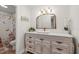 Elegant bathroom with a decorative vanity, gold accents, and a shower featuring a charming, whimsical curtain design at 192 Maple Wood Dr, Lawrenceville, GA 30046