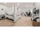 Spacious bedroom featuring a four-poster bed, a comfortable workspace, and neutral tones creating a cozy atmosphere at 192 Maple Wood Dr, Lawrenceville, GA 30046