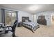 Comfortable bedroom with a king-size bed, neutral tones, and large windows for natural light at 192 Maple Wood Dr, Lawrenceville, GA 30046