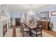 Elegant dining room featuring a crystal chandelier, fireplace, and hardwood flooring at 192 Maple Wood Dr, Lawrenceville, GA 30046
