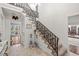 Grand foyer with marble flooring, wrought iron staircase and chandelier at 192 Maple Wood Dr, Lawrenceville, GA 30046