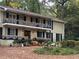 Two-story home with festive fall decor on the porch and balconies, enhancing curb appeal at 192 Maple Wood Dr, Lawrenceville, GA 30046
