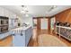 Large kitchen with hardwood floors, stainless steel appliances, white cabinets and island at 192 Maple Wood Dr, Lawrenceville, GA 30046
