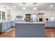 Charming kitchen with an island, stainless steel appliances, white cabinets, and hardwood floors at 192 Maple Wood Dr, Lawrenceville, GA 30046