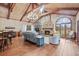 Warm living room features a stone fireplace, vaulted ceilings, hardwood floors, and comfortable seating at 192 Maple Wood Dr, Lawrenceville, GA 30046