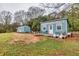 Charming, light blue outbuildings with welcoming porches, a small yard, and outdoor seating at 192 Maple Wood Dr, Lawrenceville, GA 30046