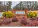 Entrance sign for Forest Hills neighborhood, framed by manicured shrubs and trees along the road at 192 Maple Wood Dr, Lawrenceville, GA 30046