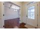 Inviting foyer with hardwood floors, wainscoting, and a view into the dining room at 7040 Tybridge St, Cumming, GA 30040