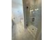 Bathroom with a glass-enclosed shower, soaking tub, and marble-look tile at 135 Henley St, Canton, GA 30114