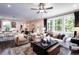 Open concept living room connected to the kitchen, featuring hardwood floors and natural light at 135 Henley St, Canton, GA 30114