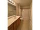 Bathroom featuring wood cabinets, double vanity, and a shower-tub combination at 1696 Tailmore Ln, Lawrenceville, GA 30043