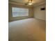 Bedroom with carpet, ceiling fan, and a big window at 1696 Tailmore Ln, Lawrenceville, GA 30043