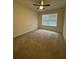 Bedroom with neutral carpet, ceiling fan, and natural light from the window at 1696 Tailmore Ln, Lawrenceville, GA 30043