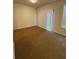 Bright bedroom featuring carpeted floors and sliding glass door at 1696 Tailmore Ln, Lawrenceville, GA 30043