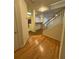 Bright entryway featuring hardwood floors, white trim, and stairway at 1696 Tailmore Ln, Lawrenceville, GA 30043