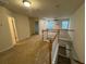 Hallway featuring neutral carpeting, white railing and multiple doorways at 1696 Tailmore Ln, Lawrenceville, GA 30043