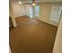 Bright living room featuring carpeted floors, windows, and natural lighting at 1696 Tailmore Ln, Lawrenceville, GA 30043