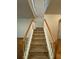 Carpeted staircase with white railing and wood accents leads to the upper level at 1696 Tailmore Ln, Lawrenceville, GA 30043