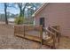 View of the home's wooden back deck, complete with railing, stairs, and access to the home's rear entrance at 2024 Collier W Cir, Decatur, GA 30032