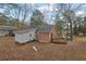 The back of the home features a wood facade, a wooden deck, and a spacious yard at 2024 Collier W Cir, Decatur, GA 30032