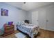 This bedroom features wood floors, light blue walls, and simple decor at 2024 Collier W Cir, Decatur, GA 30032