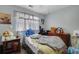 Bedroom with wood floors, natural light from the window, and neutral paint at 2024 Collier W Cir, Decatur, GA 30032