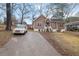 Inviting home showcasing a wood facade, a front porch, and a long driveway at 2024 Collier W Cir, Decatur, GA 30032