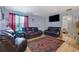 Comfortable living room featuring leather couches, a TV, and a rug at 2024 Collier W Cir, Decatur, GA 30032