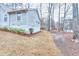 Backyard view showing the side of the house and grass at 2370 Old Mill Sw Dr, Conyers, GA 30094