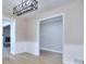 Bright dining room featuring wainscoting, wood-look floors, and a modern light fixture at 2370 Old Mill Sw Dr, Conyers, GA 30094