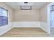 Open dining room area with wood-look floors, wainscoting, and a modern light fixture at 2370 Old Mill Sw Dr, Conyers, GA 30094