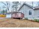 View of the side of the home featuring a wooden porch and large 2 car garage at 2370 Old Mill Sw Dr, Conyers, GA 30094