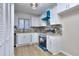 This kitchen is bright and airy, featuring white cabinets and modern appliances at 2370 Old Mill Sw Dr, Conyers, GA 30094