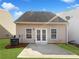 Home exterior with a walkout concrete patio, lawn and french doors to backyard at 180 Fieldview Ln, Covington, GA 30016