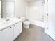 This bathroom features a shower-tub combo and a large mirror at 180 Fieldview Ln, Covington, GA 30016