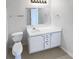 Bathroom features a white vanity with drawers and cabinets, a toilet, and a towel rack at 180 Fieldview Ln, Covington, GA 30016
