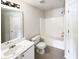 Clean, bright bathroom with a shower-tub combo, white vanity, and modern fixtures at 180 Fieldview Ln, Covington, GA 30016