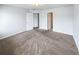 Bare bedroom showcasing neutral carpet and two doors, suggesting ample closet space at 180 Fieldview Ln, Covington, GA 30016