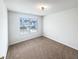 This bedroom features a large window and plush carpeting at 180 Fieldview Ln, Covington, GA 30016