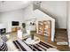 Bright, staged living room featuring a fireplace, hardwood floors, and vaulted ceilings at 180 Fieldview Ln, Covington, GA 30016