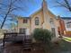 Two-story home featuring a chimney, large windows, a white door, and a wooden deck at 6812 Wynbrooke Cv, Stone Mountain, GA 30087