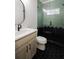 Modern bathroom with a black and sage green color scheme, featuring stylish fixtures and unique tile work at 3128 Cedar St, Scottdale, GA 30079