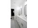 Modern bathroom featuring double sinks, long countertop, and decorative patterned floor tile leading to bath at 3128 Cedar St, Scottdale, GA 30079