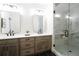 Bright bathroom featuring a double vanity, modern fixtures, and a glass-enclosed shower with marble tile at 3128 Cedar St, Scottdale, GA 30079