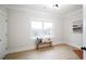 A serene bedroom with natural light from a large window and a cozy bench at 3128 Cedar St, Scottdale, GA 30079