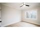 Sunlit bedroom with neutral walls, hardwood floors, ceiling fan and a large window overlooking a green yard at 3128 Cedar St, Scottdale, GA 30079