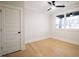 Minimalist bedroom featuring a ceiling fan, modern window design, and hardwood floors at 3128 Cedar St, Scottdale, GA 30079