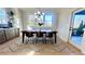 Dining area with natural light, a modern chandelier, and adjacent access to a covered outdoor space at 3128 Cedar St, Scottdale, GA 30079